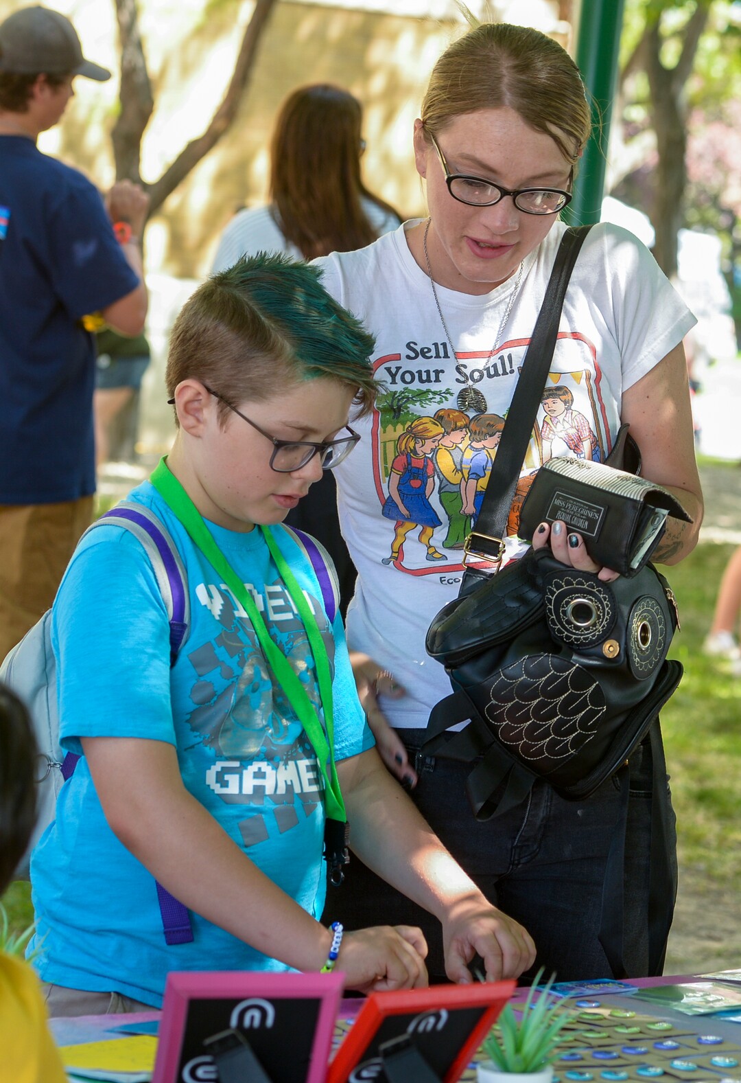 (Leah Hogsten  |  The Salt Lake Tribune)  Keegan Perkins, 11, and his mother Alyssa Tate purchase custom button pins made by Qiya Alandia, 11, at her Sitali Moon booth at Craft Lake City DIY Festival at Kid Row, where children 14 and under make and sell their products. Craft Lake CityÕs DIY Festival is UtahÕs largest local, three day arts festival with over 300 artisans, DIY engineers, vintage vendors and craft food creators.
