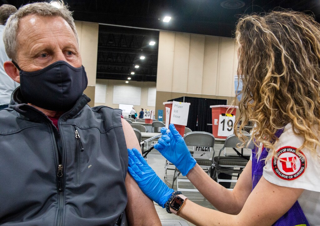 (Rick Egan | The Salt Lake Tribune)  Kris Romijin gets his Covid-19 vaccination from MacKenzie Heffernan, at the Mountain America Expo site in Sandy on Monday, March 8, 2021.