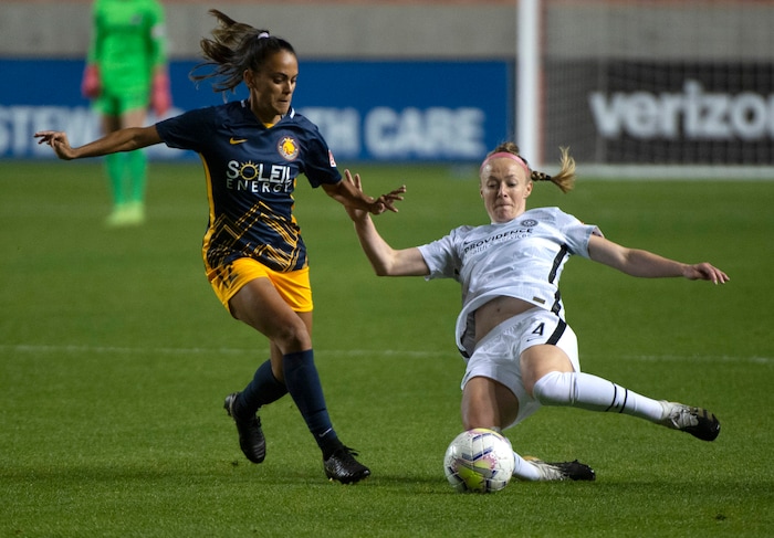 (Rick Egan | The Salt Lake Tribune) Utah Royals FC midfielder Taylor Lytle (12) goes for the ball along with Portland Thorns FC defender Becky Sauerbrunn (4), in soccer action between Utah Royals FC and Portland Thorns FC at Rio Tinto Stadium, on Saturday, Oct. 3, 2020.