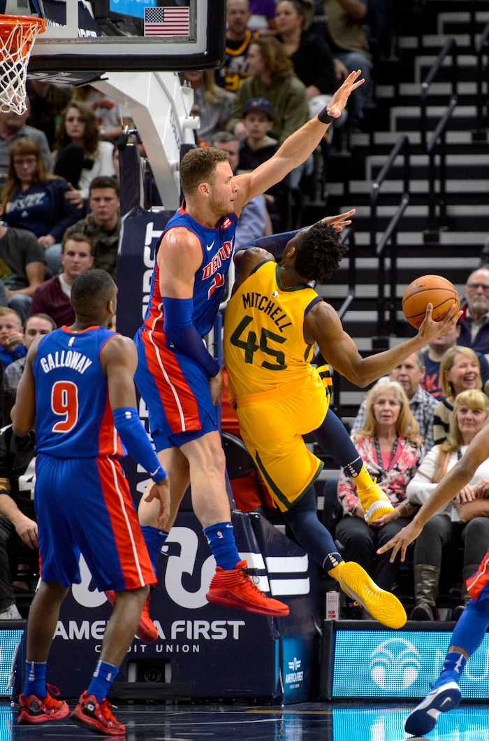 (Steve Griffin  |  The Salt Lake Tribune)  Utah Jazz guard Donovan Mitchell (45) drives into Detroit Pistons forward Blake Griffin (23) during the Utah Jazz versus Detroit Pistons at Vivint Smart Home Arena in Salt Lake City Tuesday March 13, 2018.