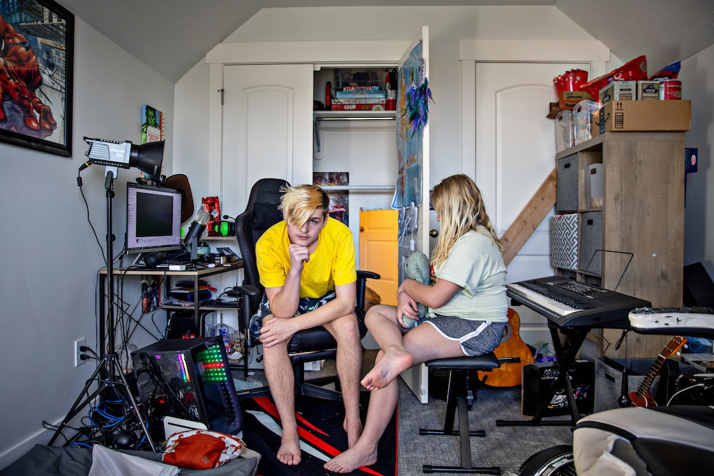 (Kim Raff for ProPublica) Ty Larson, left, livestreams on TikTok from a barricaded bedroom. Police have attempted to return him and his sister, Brynlee Larson, to the custody of their father, who they say sexually abused them.