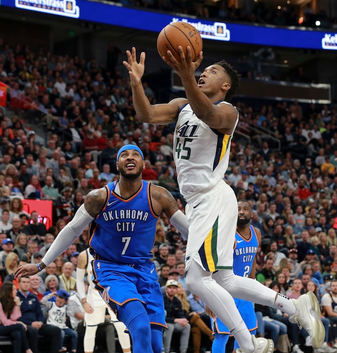 Utah Jazz guard Donovan Mitchell (45) shoots in front of Oklahoma City Thunder forward Carmelo Anthony (7) during the second half of an NBA basketball game Saturday, Oct. 21, 2017, in Salt Lake City. The Utah Jazz won 96-87. (AP Photo/Chris Nicoll)