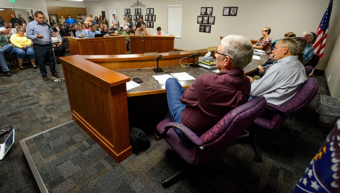 (Steve Griffin  |  The Salt Lake Tribune)  Northwest Band Tribal Council Chairman, Darren Parry, left, addresses the  Wellsville City Council about his concerns with the Sham Battle Wednesday night at the Wellsville City Hall in Wellsville, Utah Wednesday September 20, 2017. The mayor and the city council created a committee to decide the future of the Sham Battle where white residents paint their bodies red, put on war paint, and whoop and fire guns, attacking the humble settlers before being driven off by the cavalry troops. 