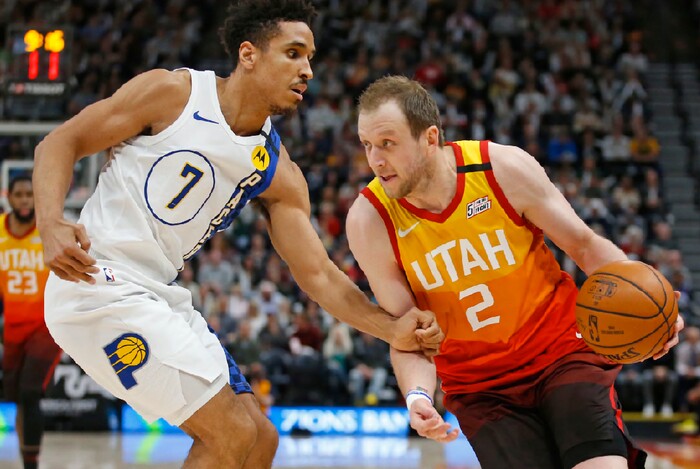 Indiana Pacers guard Malcolm Brogdon (7) guards Utah Jazz forward Joe Ingles (2) in the second half of an NBA basketball game Monday, Jan. 20, 2020, in Salt Lake City. (AP Photo/Rick Bowmer)