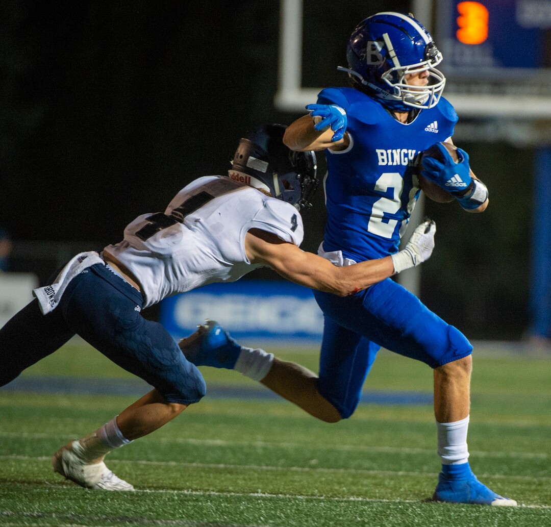 (Rick Egan  |  The Salt Lake Tribune)     Ryan Cahoon grabs running back Saia Lomu as he  runs the ball for Bingham, in prep action between the Bingham Miners and the Corner Canyon Chargers, at Bingham High onFriday, Aug. 28, 2020.