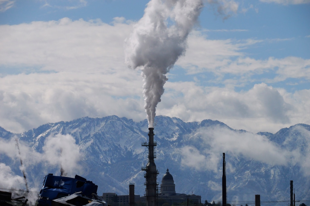 (Rick Bowmer | AP) The Utah State Capitol, rear, is shown behind an oil refinery on Thursday, May 12, 2022, in Salt Lake City.
