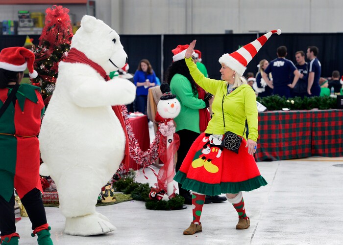(Scott Sommerdorf   |  The Salt Lake Tribune)   The Coca Cola Polar Bear gets a high five as patients from Primary ChildrenÕs and Shriners Hospitals were treated to a unique experience on Saturday at a Delta hangar of the Slat Lake International airport. They boarded a Boeing 737 which taxied to their final destinationÑSantaÕs Winter Wonderland, Saturday, December 2, 2017.  