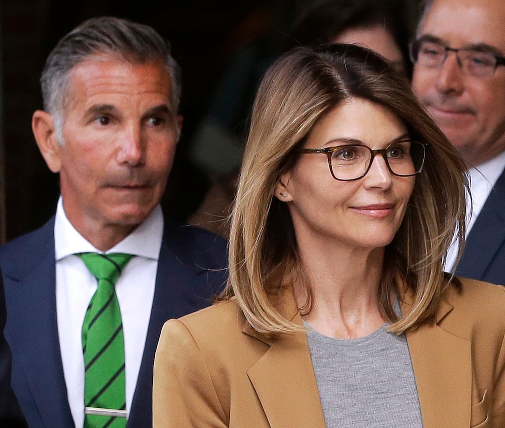 FILE - In this April 3, 2019, file photo, actress Lori Loughlin, front, and husband, clothing designer Mossimo Giannulli, left, leave federal court in Boston after facing charges in a nationwide college admissions bribery scandal. Loughlin and Giannulli are scheduled for a hearing in the bribery scam case on Tuesday, Aug. 27 in Boston. (AP Photo/Steven Senne, File)