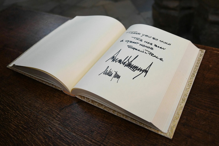 The visitors books signed by US President Donald Trump and his wife Melania after their tour of Westminster Abbey in central London, Monday, June 3, 2019. Trump is on a three-day state visit to Britain. (Stefan Rousseau/Pool Photo via AP)
