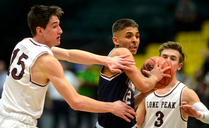 (Steve Griffin  |  The Salt Lake Tribune) Herriman's Jael Vaughn splits the Lone Peak defense during 6A basketball playoff game at the Utah Valley UniversityÕs UCCU Center in Provo Tuesday Feb. 27, 2018.