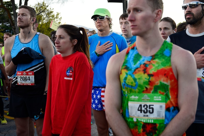 (Scott Sommerdorf | The Salt Lake Tribune)Runners listen to the national anthem prior to leaving the starting line of the Salt Lake City marathon, Saturday, April 21, 2018.