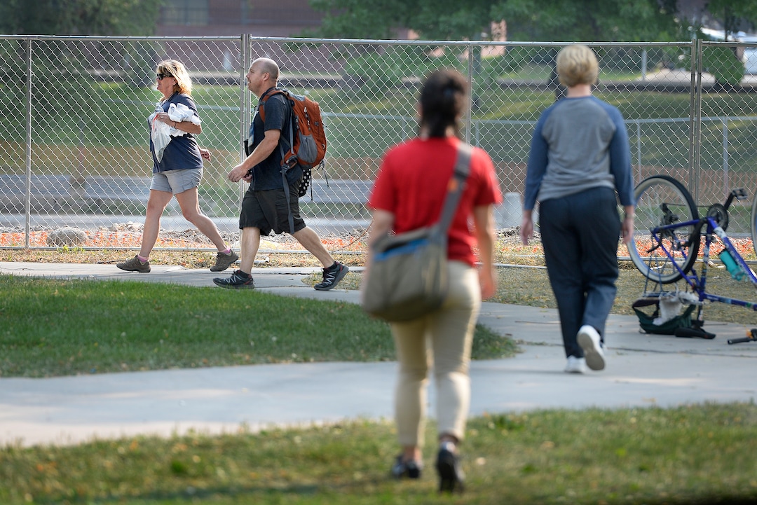 (Scott Sommerdorf   |  The Salt Lake Tribune)   Machele Nieto, left, followed by Sean Spalding, of the Volunteers of America, hike over to a group of homeless people in Fairmont Park to see if they are in need of water, food, or other supplies, Wednesday, September 6, 2017.