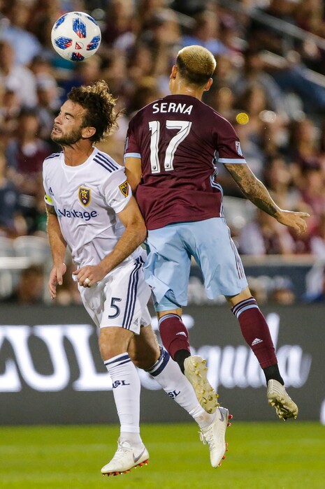 Real Salt Lake midfielder Kyle Beckerman (5) heads the ball next to Colorado Rapids midfielder Dillon Serna (17) during the first half of an MLS soccer match Saturday, Aug. 25, 2018, in Denver. (AP Photo/Jack Dempsey)