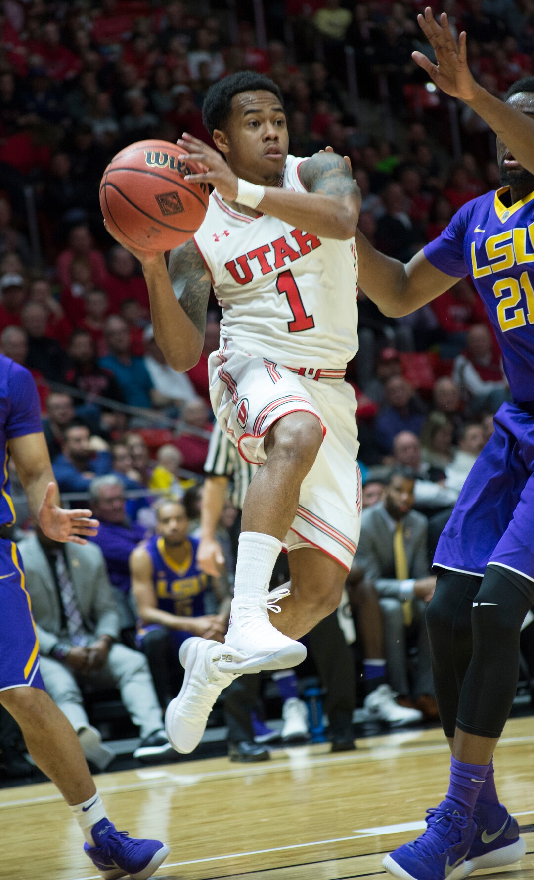 (Rick Egan  |  The Salt Lake Tribune)    Utah Utes guard Justin Bibbins (1) looks to pass, as LSU Tigers forward Aaron Epps (21) defends, in NIT playoff action between Utah Utes and LSU Tigers at the Jon M. Huntsman Center, Monday, March 19, 2018.