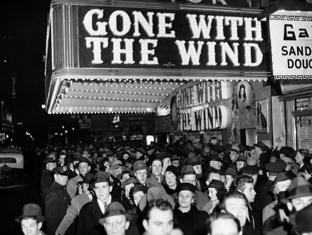 FILE - In this Dec. 19, 1939 file photo, a crowd walks past the Astor Theater during the Broadway premiere of "Gone With the Wind" in New York. A Memphis, Tennessee, theater has cancelled an annual screening of the classic 1939 film because of racially insensitive content. (AP Photo, File)