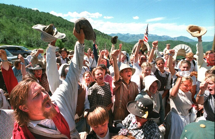 Rick Egan  | Tribune File Photo 

Hand cart companies celebrate upon reaching the top of Big Mountain Monday morning.   