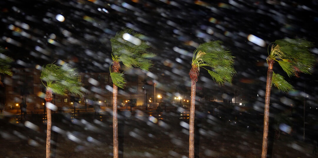 (Eric Gay | The Associated Press) Rain is blown past palm trees as Hurricane Harvey makes landfall, Friday, Aug. 25, 2017, in Corpus Christi, Texas. Harvey intensified into a hurricane Thursday and steered for the Texas coast with the potential for up to 3 feet of rain, 125 mph winds and 12-foot storm surges in what could be the fiercest hurricane to hit the United States in almost a dozen years.