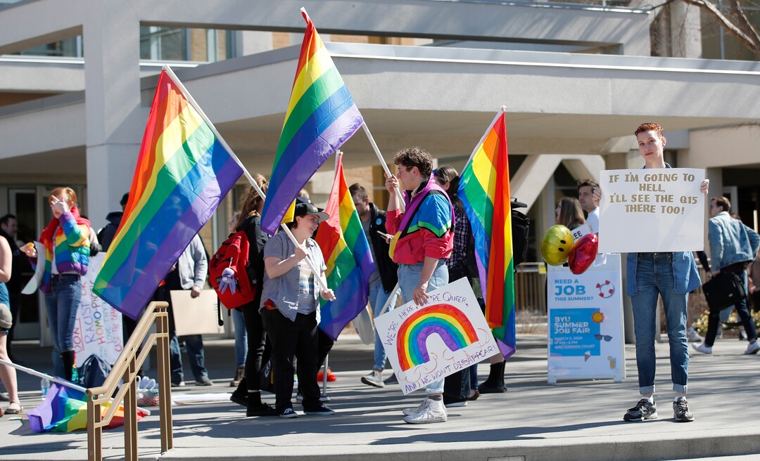 (George Frey | Special to The Tribune) Students and others gather in front of the Ernest L. Wilkinson Student Center on the campus of Brigham Young University to protest BYU's rollback of a newly announced policy change on LGBTQ students on March 5, 2020, in Provo.