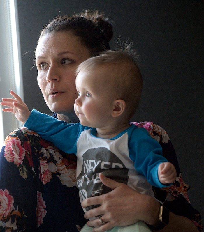 Al Hartmann  |  The Salt Lake Tribune  Janell Lewis holds her baby Evie at a press conference at the Utah Public Health Laboratory Wednesday Jan. 31. Evie was was tested for spinal muscular atrophy because the Lewis' first daughter Blakely died from the genetic mutation. Evie received treatment for the condition early on.  The Utah Department of Health announced they're going to start testing every infant born in the state for spinal muscular atrophy. The neurodegenerative disease is the leading genetic cause of death for infants, affecting one in 11,000.  