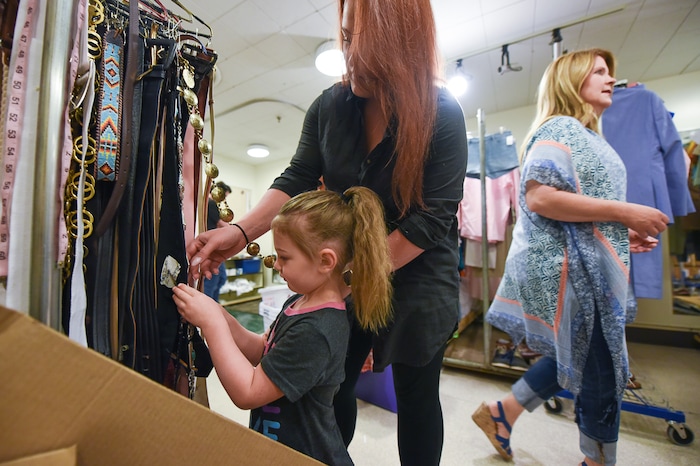 (Francisco Kjolseth  |  The Salt Lake Tribune)  Utah actor Megan Shenefelt, left, is joined by her daughter Sovay, 3, as as she expresses interest in rack covered with different types of belts used in shows, including the upcoming musical "Mamma Mia!" at Pioneer Theatre. 