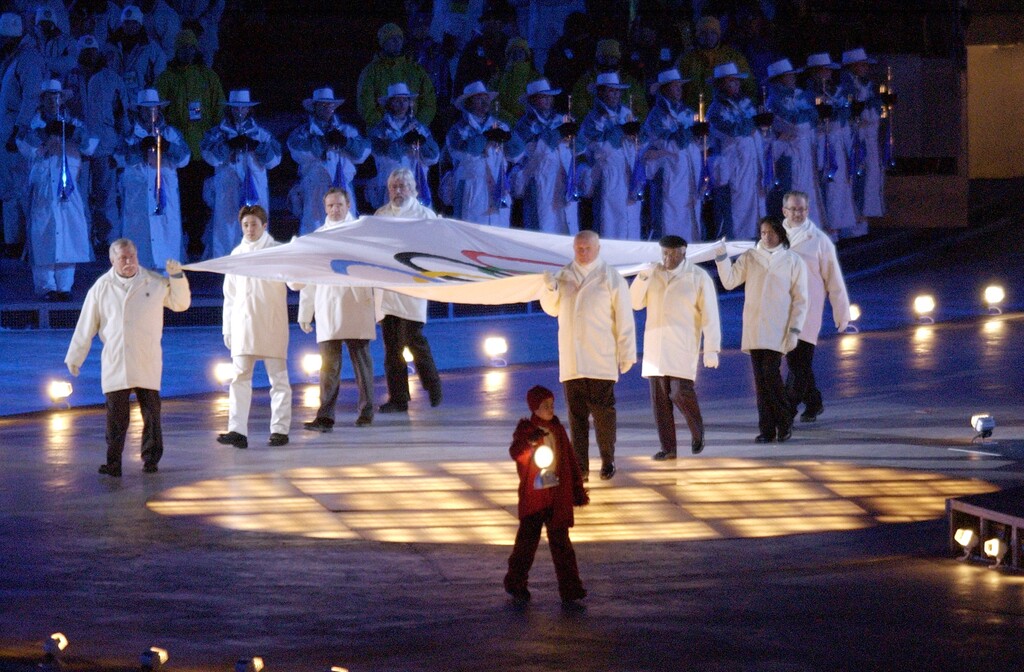 A child with a lantern leads the Olympic Flag into the stadium during the Olympic Opening Ceremonies Feb. 8, 2002. Griffin/photo