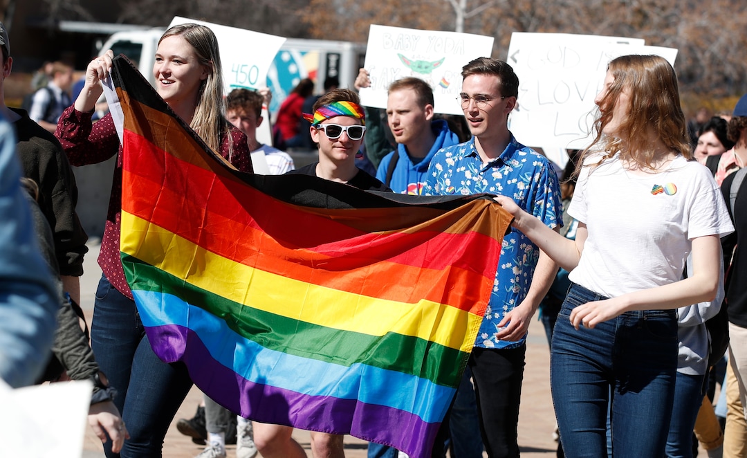 (George Frey  |  special to The Salt Lake Tribune) BYU students and others gather in front of the Ernest L. Wilkinson Student Center on the campus of Brigham Young University to protest BYUÕs rollback of a newly announced policy change on LGBTQ students on March 5, 2020 in Provo, Utah.