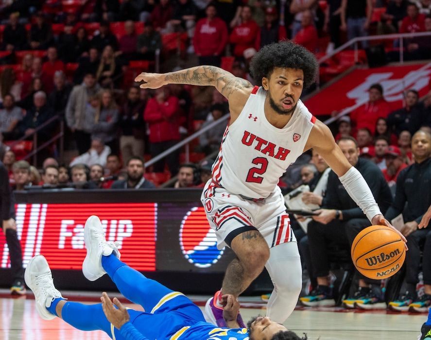 (Rick Egan | The Salt Lake Tribune) Utah guard Mike Saunders Jr. (2) draws a foul on UCLA Bruins guard Tyger Campbell (10), in PAC-12 basketball action between Utah Utes and UCLA Bruins, at the Jon M. Huntsman Center, Thursday, February. 23, 2022.