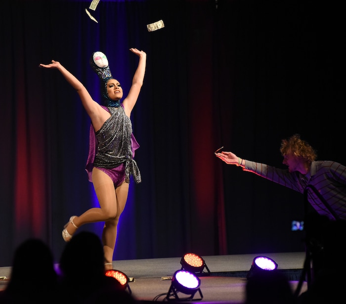 (Francisco Kjolseth  |  The Salt Lake Tribune)  Jared Espiritu, who goes by his drag queen name Aliyah, throws bills into the air being presented by fans as Utah State University, hosts their first ever drag show recently. Espiritu who lovingly calls his mannequin head Ornacia, put on an athletic and spirited performance as the crowd cheered him on.