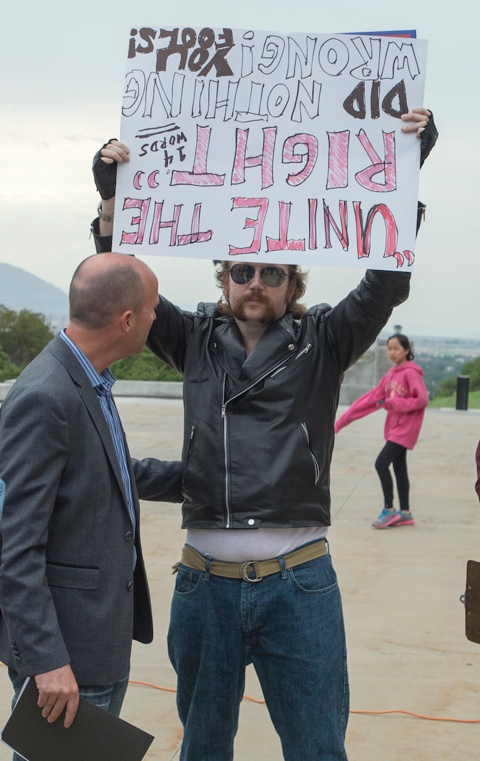 (Rick Egan  |  The Salt Lake Tribune) Mia  Lt. Governor Spencer Cox tries to give a protestor a hug after he spoke at the "One Utah" Rally for Unity at the State Capitol, Monday, August 14, 2017.


