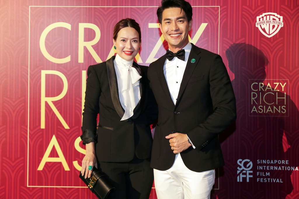 (Don Wong | The Associated Press) Actor Pierre Png and his wife, Andrea De Cruz, pose for photographers as they arrive for the red carpet screening of the movie "Crazy Rich Asians" on Tuesday, Aug. 21, 2018, in Singapore.