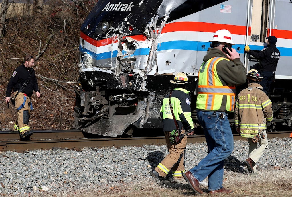 Emergency personnel inspect the lead engine of an Amtrak train that was carrying multiple Republican lawmakers that crashed into a garbage truck  in Crozet, Va., on Wednesday, Jan. 31, 2018.  A chartered train carrying dozens of GOP lawmakers to a Republican policy retreat in West Virginia struck a garbage truck in a rural Virginia town Wednesday.  (Zack Wajsgras/The Daily Progress via AP)