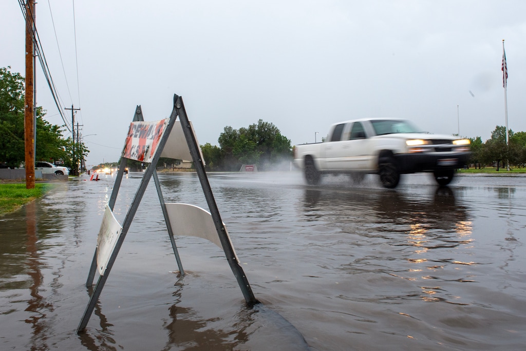(Chris Samuels | The Salt Lake Tribune) Cars drive through a flooded road in West Valley City after monsoonal rain, Wednesday, Aug. 2, 2023.