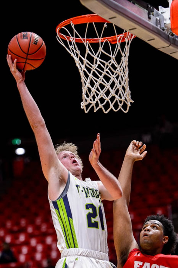 (Trent Nelson | The Salt Lake Tribune)  East vs. Timpanogos, 5A State high school basketball tournament at the Huntsman Center in Salt Lake City, Wednesday Feb. 28, 2018. Timpanogos's Logan Wilkey (20) defended by East's Mikey Frazier (45).