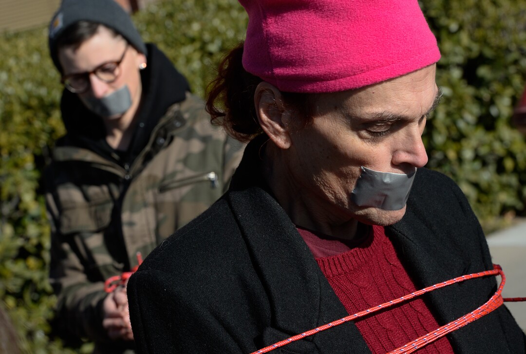 (Francisco Kjolseth  |  The Salt Lake Tribune)  Lesley Ann Shaw, left, and Rachel Edward join other activists in Utah by being bound and duct taped outside of Salt City Tattoo on Friday, Dec. 22, 2017, to protest following an Instagram post made by the shopÕs official Instagram account. The post in question was of a gift provided during the shopÕs white elephant exchange, a gift one of the artists at the parlor called a Òrape kit,Ó containing leather gloves, black duct tape, a bottle of lubricant, rope, and a knife.