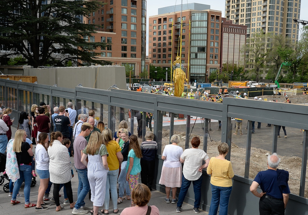 (Francisco Kjolseth  |  The Salt Lake Tribune) People gather to get a closer look of the Angel Moroni statue after it was pulled from atop the Salt Lake Temple of The Church of Jesus Christ of Latter-day Saints on Monday, May 18, 2020. The temple closed in December for seismic upgrades and sustained minor damager during the March 18, 2020, magnitude 5.7 earthquake when the trumpet held by the angel fell off and several smaller spire stones were displaced.