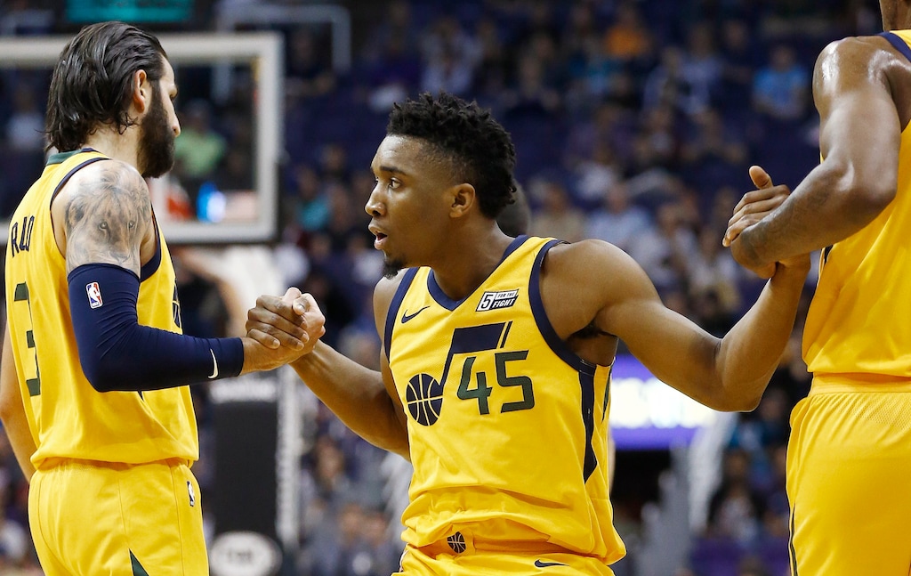 After being fouled on a 3-point basket, Utah Jazz guard Donovan Mitchell (45) is helped up off the floor by guards Ricky Rubio (3) and Joe Johnson, right, during the first half of an NBA basketball game Friday, Feb. 2, 2018, in Phoenix. (AP Photo/Ross D. Franklin)