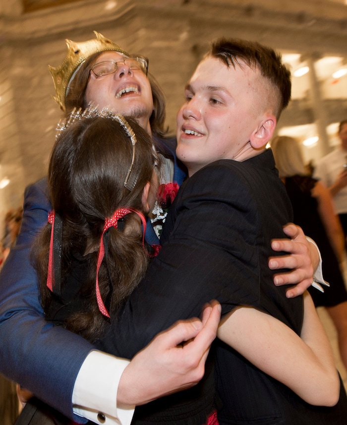 (Leah Hogsten  |  The Salt Lake Tribune) Newly crowned prom king Zach Emanuel hugs the queen Amanda Baird and her date AJ Heath. Three virtual charter schools, Utah Virtual Academy, Utah Connections Academy and Mountain Heights Academy, co-hosted prom for their students, Friday, April 27, 2018. 