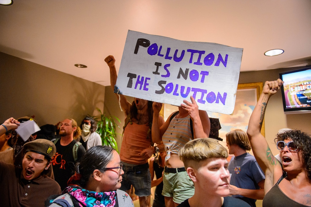 (Trent Nelson  |  The Salt Lake Tribune) Protesters occupy the Chamber of Commerce office in Salt Lake City on Tuesday, July 9, 2019. Dozens of people showed up to protest the proposed Inland Port and ended up clashing with police, resulting in temporary street closures and arrests.