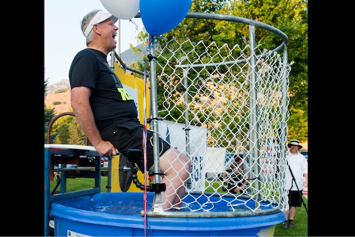 (Rick Egan  |  The Salt Lake Tribune)  Danny Ainge reacts after nearly being dunked, as he sits in a dunking booth, during a fundraiser in Provo for Tanner Ainge, who is running for congress, in Utah’s third district. Monday, August 7, 2017.
