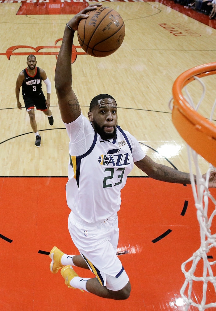 Utah Jazz forward Royce O'Neale drives to the basket as Houston Rockets guard Chris Paul, back left, watches during the first half in Game 2 of an NBA basketball second-round playoff series Wednesday, May 2, 2018, in Houston. (AP Photo/Eric Christian Smith)