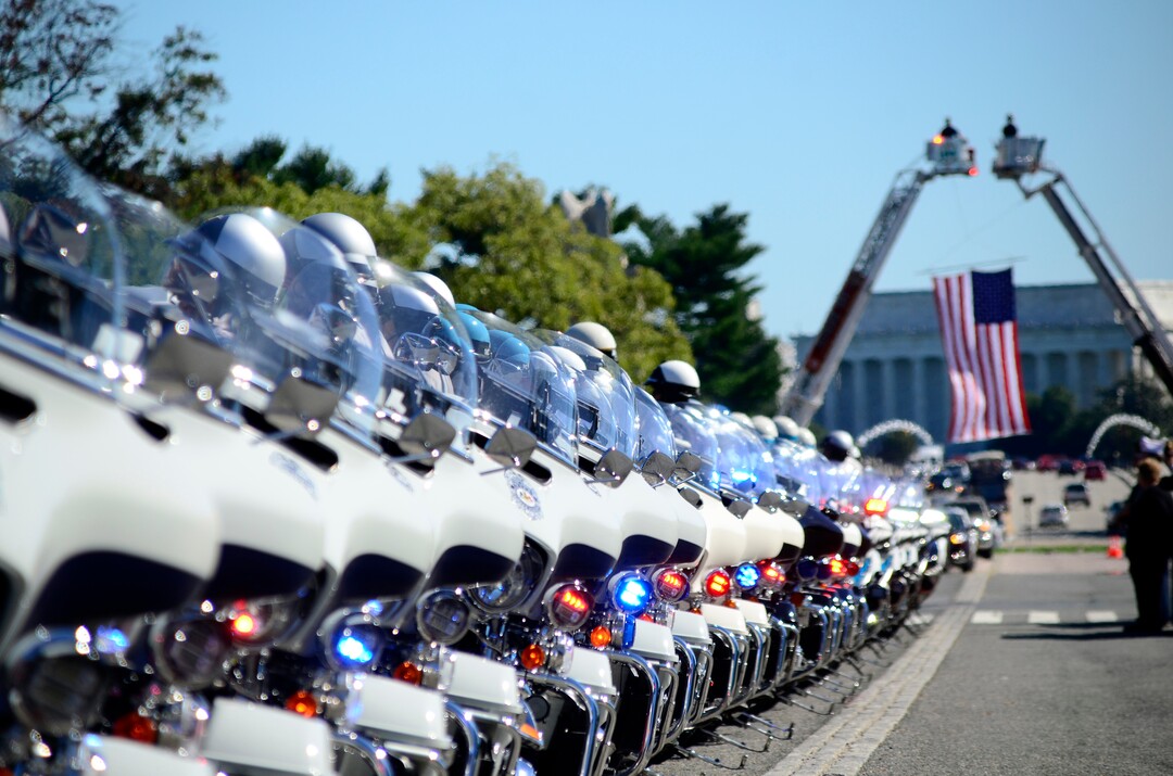 (Danny La | Special to The Tribune) Various Washington D.C. metro area motorcycle police pay their respects as the funeral procession for Staff Sgt. Taylor Hoover proceeds into Arlington National Cemetery on Friday, Sept. 24, 2021. Hoover was killed in action due to a suicide bombing in Kabul, Afghanistan on Aug. 26.