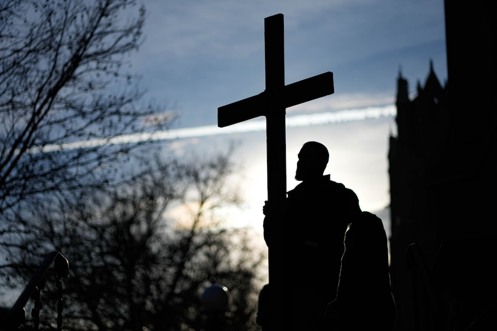 (Francisco Kjolseth | The Salt Lake Tribune) A marcher carries the cross at a Good Friday procession in Salt Lake City in 2023. Religion News Service columnist laments that Christ is being crucified around the world.