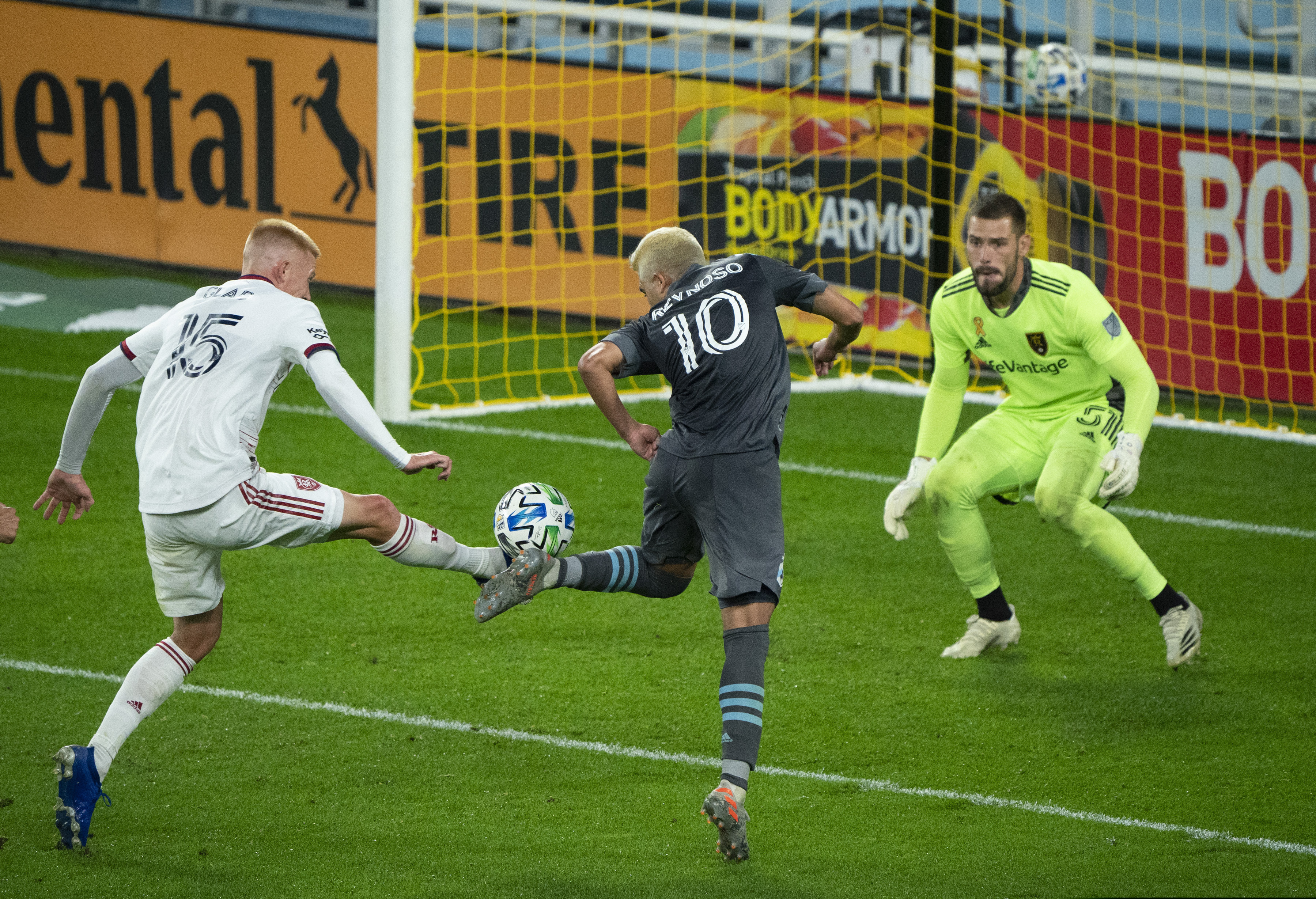 Minnesota United midfielder Emanuel Reynoso (10) and Real Salt Lake defender Justen Glad (15)  battle for the ball in front of Real Salt Lake goalkeeper Andrew Putna (51) during the second half of a MLS soccer match, Sunday, Sept. 27, 2020 in St. Paul, Minn. (Jeff Wheeler/Star Tribune via AP)