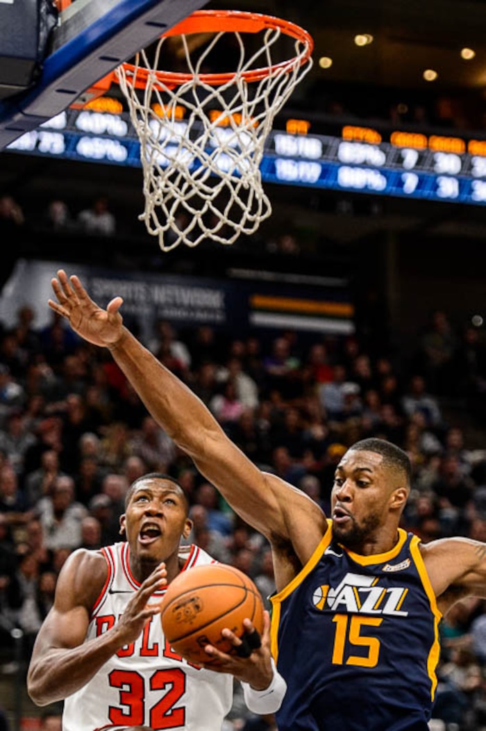 (Trent Nelson | The Salt Lake Tribune)  Chicago Bulls guard Kris Dunn (32) defended by Utah Jazz forward Derrick Favors (15) as the Utah Jazz host the Chicago Bulls, NBA basketball in Salt Lake City Wednesday November 22, 2017.