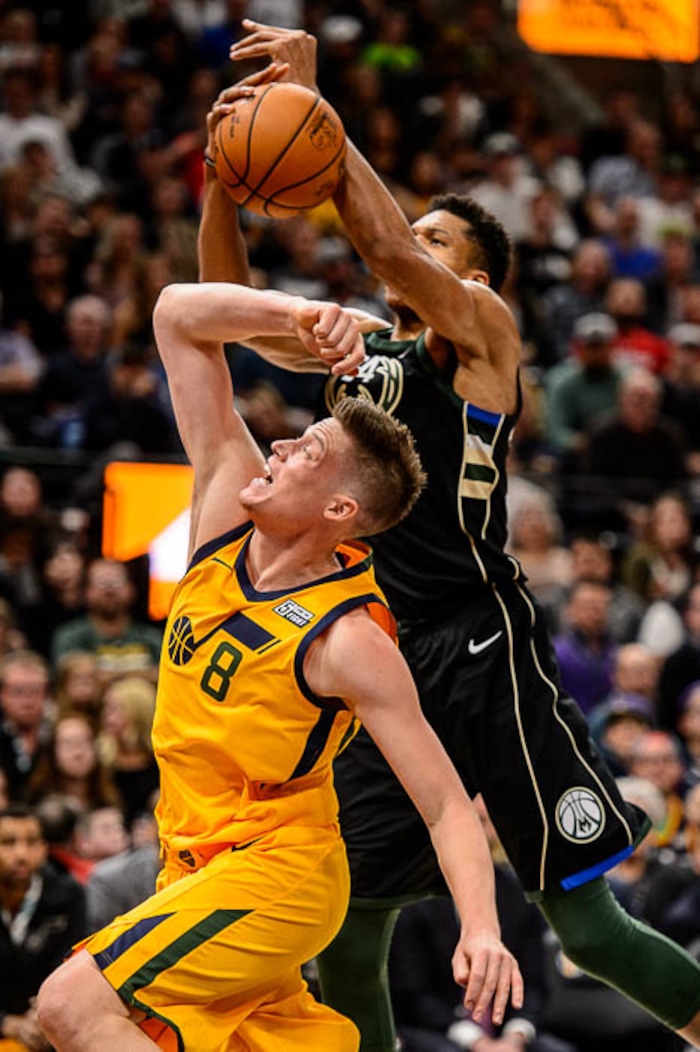 (Trent Nelson | The Salt Lake Tribune)  Milwaukee Bucks forward Giannis Antetokounmpo (34) pulls down a rebound over Utah Jazz forward Jonas Jerebko (8) as the Utah Jazz host the Milwaukee Bucks, NBA basketball in Salt Lake City Saturday November 25, 2017.