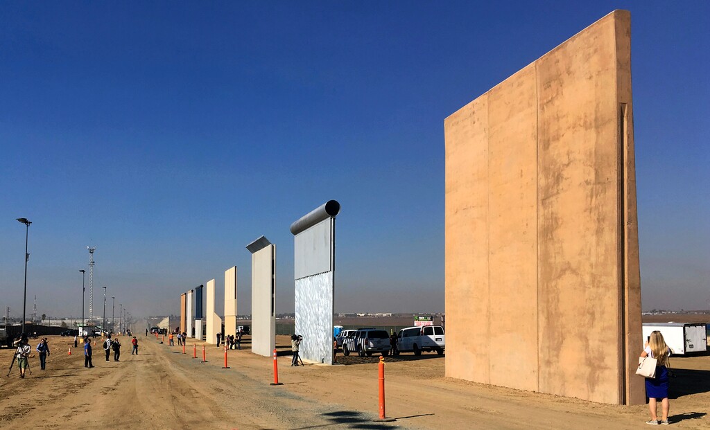 FILE - This Oct. 26, 2017 file photo shows prototypes of border walls in San Diego. The Trump administration has proposed spending $18 billion over 10 years to significantly extend the border wall with Mexico. The plan provides one of the most detailed blueprints of how the president hopes to carry out a signature campaign pledge. (AP Photo/Elliott Spagat, File)
