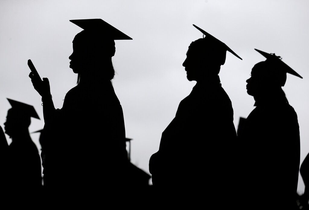 (Seth Wenig | AP file photo) In this May 17, 2018, file photo, new graduates line up before the start of the Bergen Community College commencement at MetLife Stadium in East Rutherford, N.J. A college degree has long been a ticket to the U.S. middle class. Yet a new survey shows that college graduates aren’t as likely as they once were to feel they belong to the middle class.