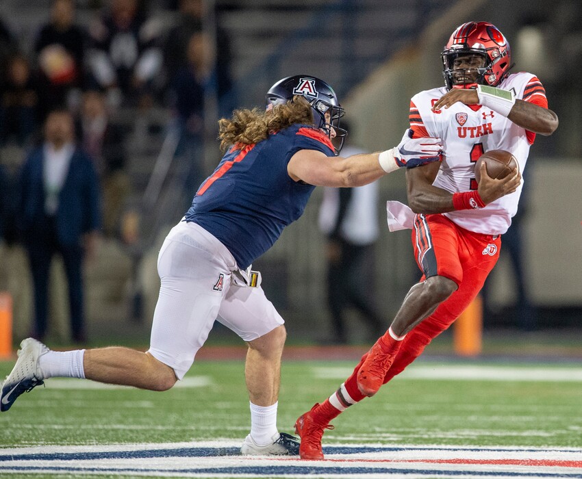 (Rick Egan  |  The Salt Lake Tribune)  Utah senior quarterback Tyler Huntley (1) tries to escape Arizona linebacker Colin Schooler during a 35-7 win last Saturday at Tucson, Ariz.