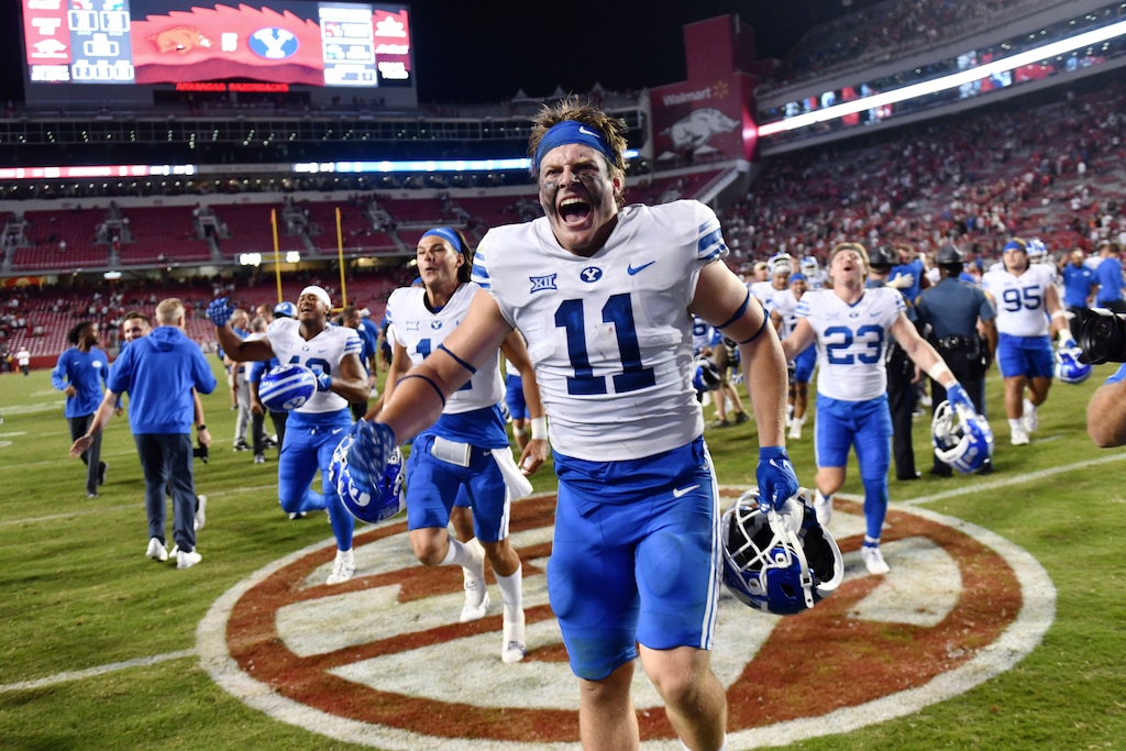 (Michael Woods | AP)  BYU linebacker Harrison Taggart (11) and teammates celebrate a win over Arkansas during an NCAA college football game Saturday, Sept. 16, 2023, in Fayetteville, Ark.