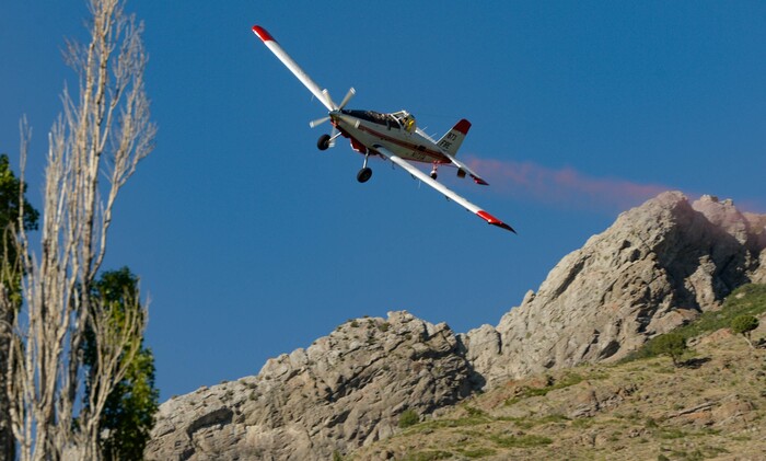 (Francisco Kjolseth  |  The Salt Lake Tribune) Fire crews battle a fire near Millcreek Canyon, on Saturday, July 11, 2020, started near 3400 South Crestwood Dr., as helicopters, single engine air tankers and multiple crews respond.